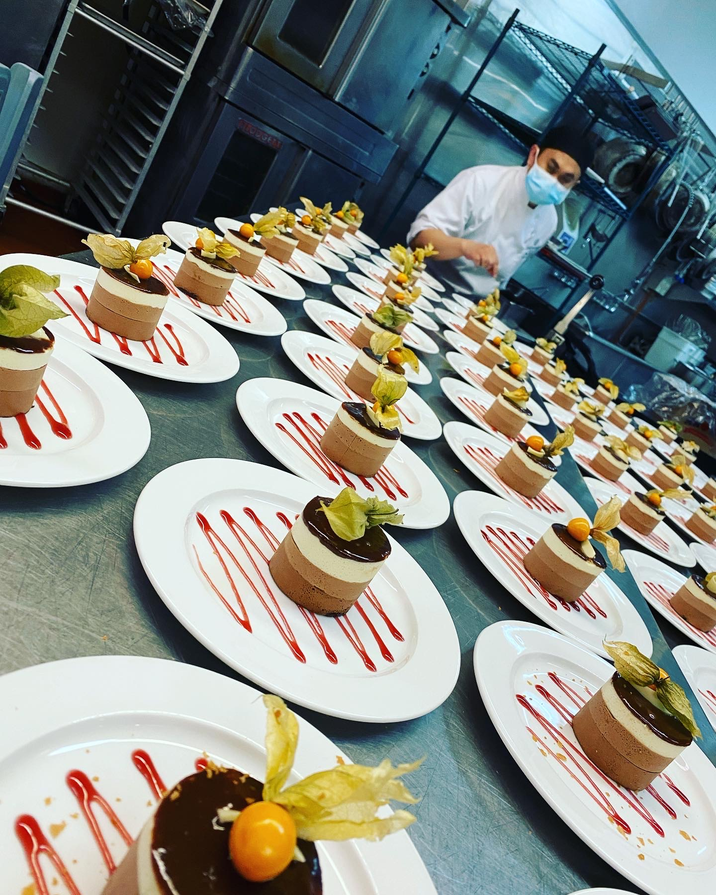 A beautifully arranged spread of breakfast and brunch items including pastries, fresh fruit, yogurt, cheese, and more on an elegant table setting.
