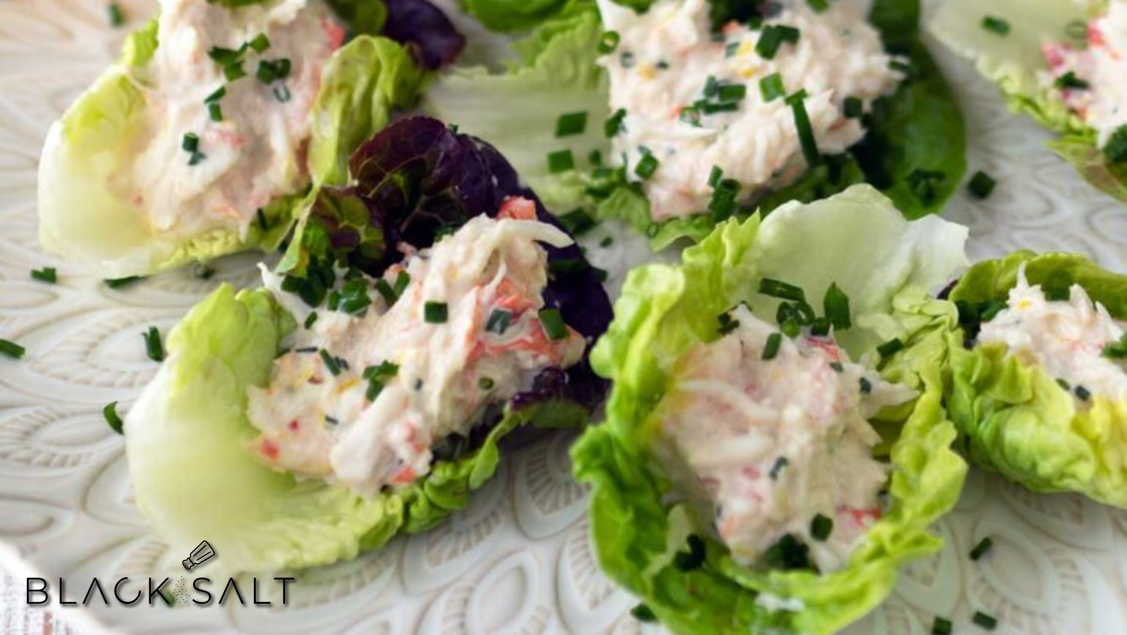 Crab Lettuce Wraps, featuring delicate and flavorful crab meat wrapped in fresh lettuce leaves, creating a light and refreshing appetizer or light meal option.