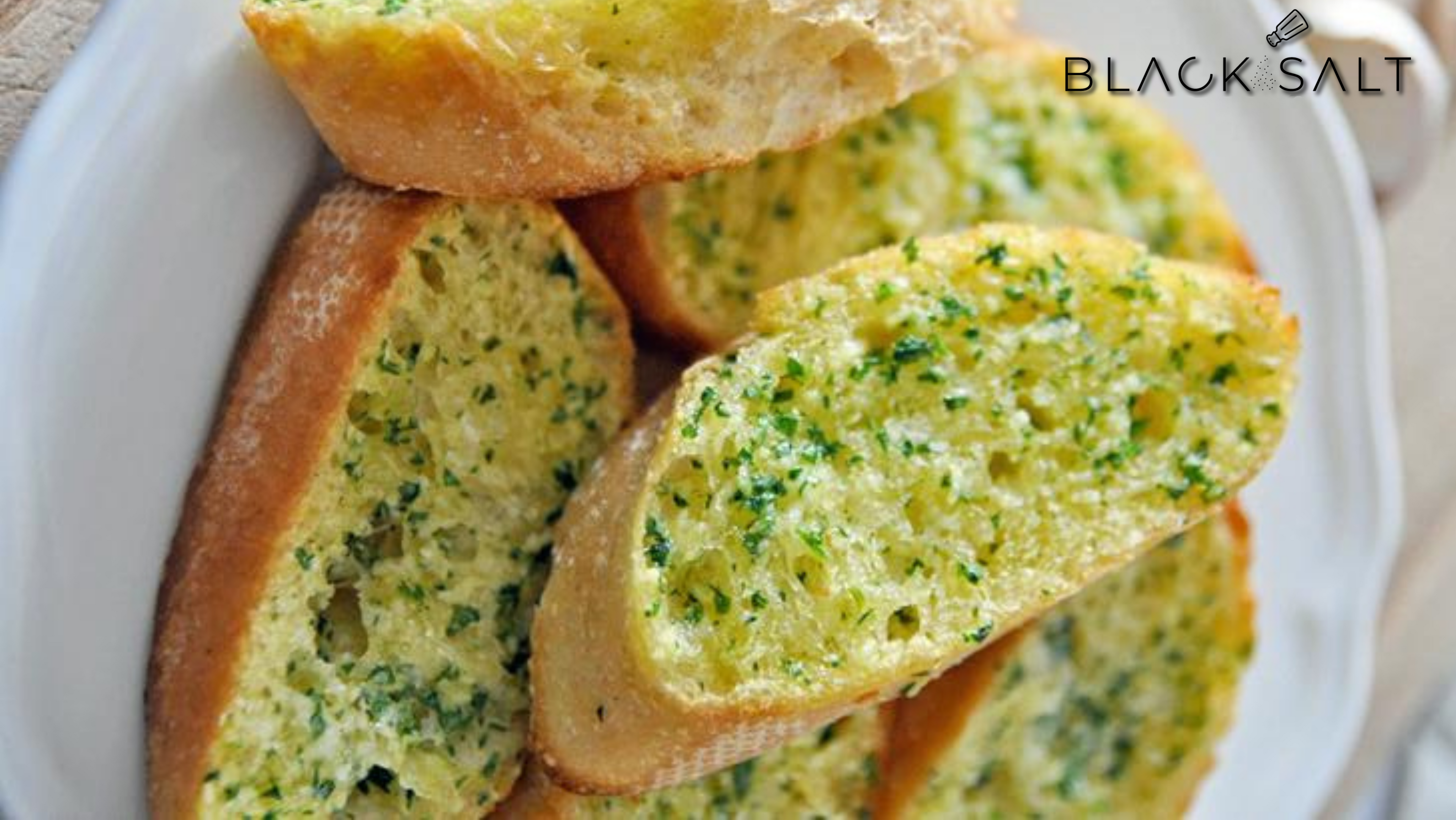 Garlic Bread, a mouthwatering side dish featuring slices of bread generously spread with garlic-infused butter, toasted to perfection, offering a fragrant and flavorful accompaniment to any meal.