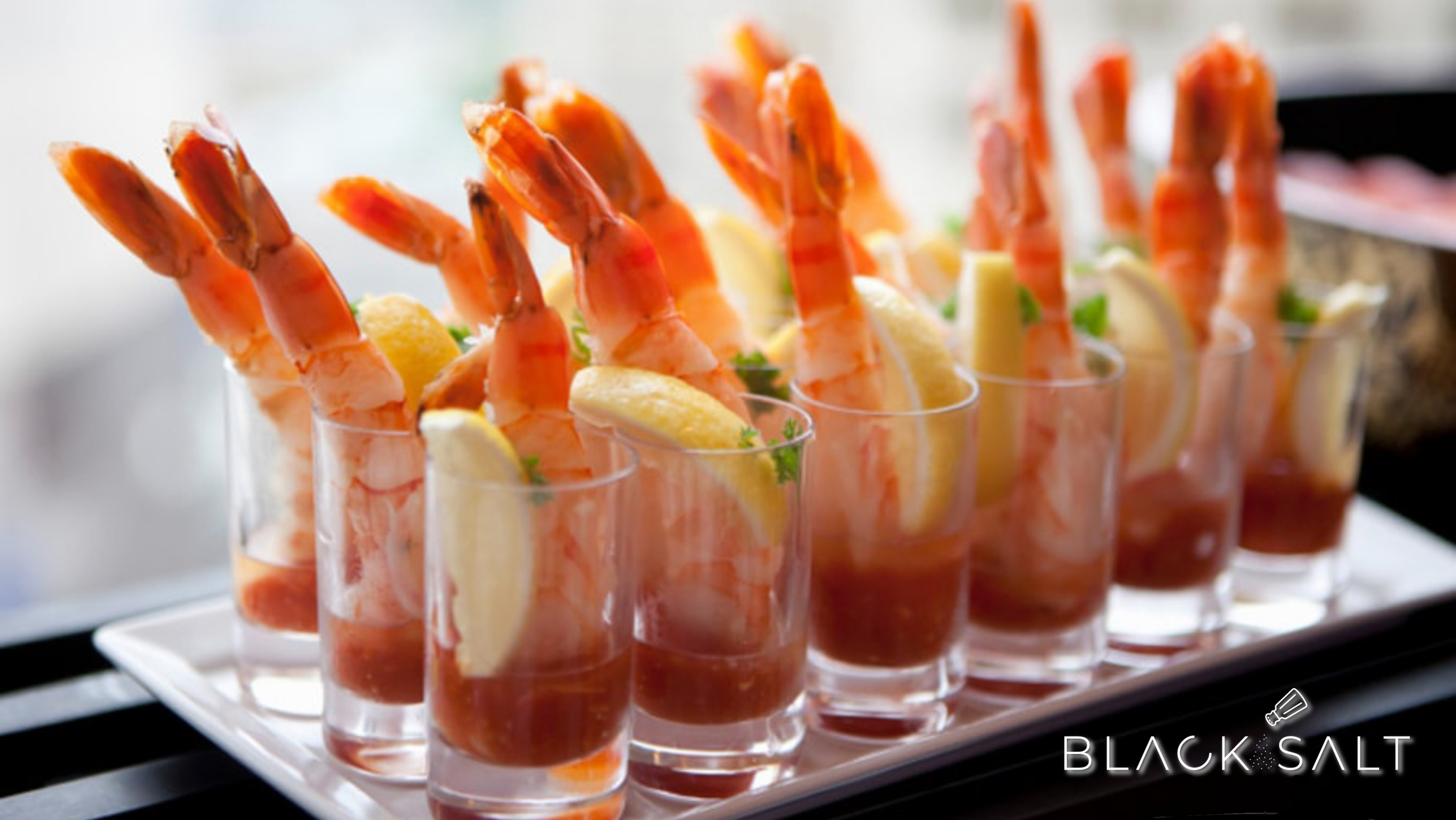 Jumbo Prawn Shooters, large and succulent prawns served in shot glasses, accompanied by a flavorful sauce or dip, creating an elegant and delicious appetizer option for your event or gathering.
