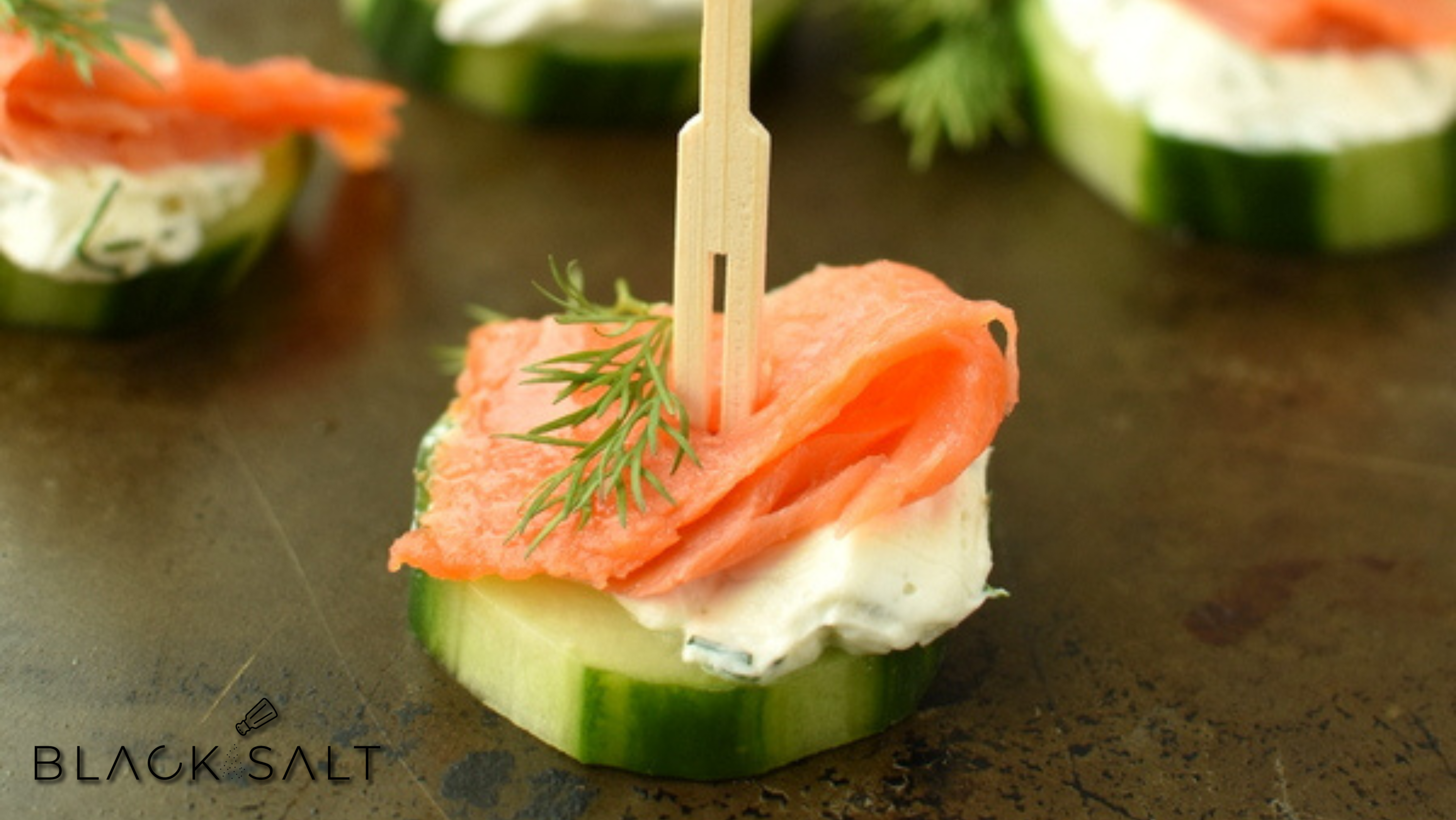 Salmon Cucumber Bites, refreshing cucumber slices topped with smoked salmon, cream cheese, and fresh herbs, offering a delightful combination of flavors and textures for an elegant and light appetizer.