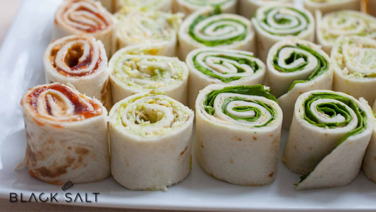 An attractive platter featuring a variety of delicious pinwheel sandwiches, showcasing a medley of flavors and fillings, perfect for any occasion.
