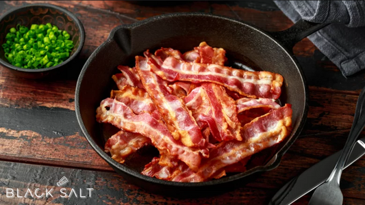 A mouthwatering tray of crispy, sizzling bacon strips, cooked to perfection and ready to be enjoyed.