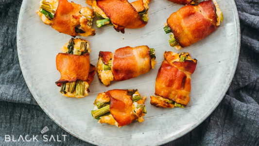 Delicious Bacon-Wrapped Asparagus, featuring tender asparagus spears wrapped in savory bacon, offering a delightful combination of flavors and textures.