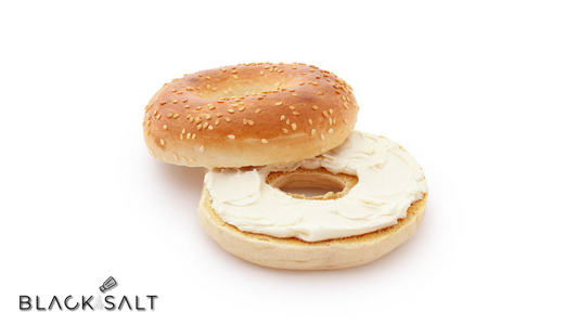 A tempting display of fresh bagels accompanied by a variety of cream cheese spreads, providing a satisfying and versatile breakfast or snack option."