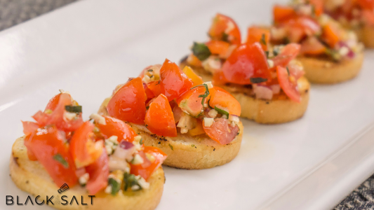 Mouthwatering Bruschetta, featuring toasted bread slices topped with a flavorful combination of diced tomatoes, fresh herbs, garlic, and olive oil, offering a delightful appetizer or snack option.