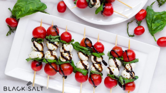 Caprese Skewers, a delightful appetizer featuring skewered cherry tomatoes, fresh mozzarella cheese, and basil leaves, drizzled with balsamic glaze, offering a burst of flavors and a visual treat.