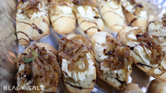 Caramelized Onion Crostini, toasted baguette slices topped with sweet and savory caramelized onions, creating a delightful appetizer with a perfect balance of flavors and textures.