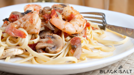 Champagne Shrimp and Pasta, a luxurious and flavorful dish featuring succulent shrimp cooked in a champagne-infused sauce, served over a bed of pasta, creating an elegant and satisfying meal.