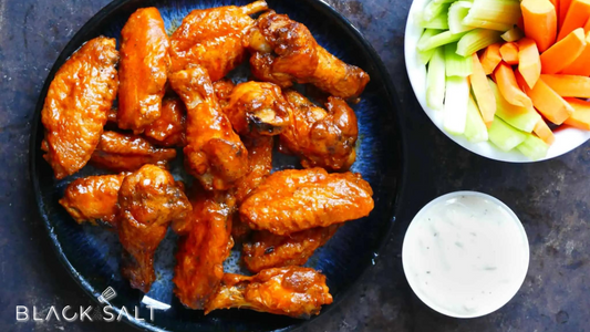 Mouthwatering Chicken Wings, crispy and flavorful, available in a variety of sauces or seasonings, perfect for snacking or as a main dish for your gathering or event.