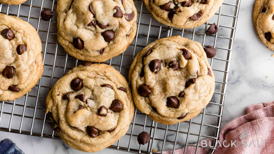 Chocolate Chip Cookies, freshly baked with a golden exterior and gooey chocolate chips, offering a classic and irresistible treat for indulging in a sweet moment.