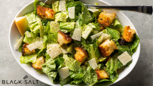 Classic Caesar Salad, featuring crisp romaine lettuce, Parmesan cheese, croutons, and a tangy Caesar dressing, offering a refreshing and flavorful salad option.