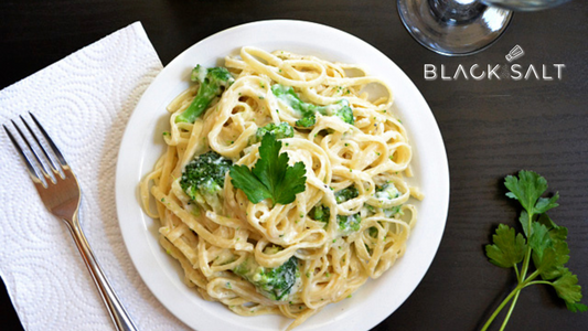 Fettuccini Alfredo, a classic Italian pasta dish featuring long, ribbon-like fettuccini noodles tossed in a creamy and rich Alfredo sauce, creating a comforting and indulgent meal option.