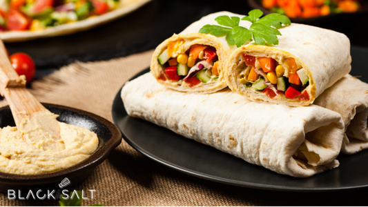 Hummus Wrap Platter, an assortment of flavorful wraps filled with creamy hummus, fresh vegetables, and other delicious ingredients, offering a satisfying and nutritious option for a variety of preferences and dietary needs.