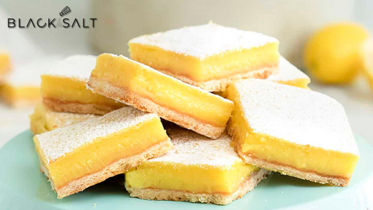 Lemon Bars, a sweet and tangy dessert consisting of a buttery shortbread crust topped with a luscious layer of lemon filling, offering a delightful balance of citrusy and sweet flavors.