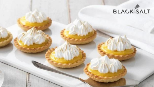 Lemon Meringue Pie Cups, individual-sized desserts with a crisp pastry crust filled with tangy lemon curd and topped with fluffy meringue, creating a delightful balance of flavors and textures.