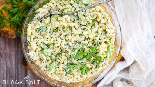 Macaroni Salad, a creamy and flavorful salad made with cooked macaroni pasta, mixed with a combination of vegetables, mayonnaise, and various seasonings, offering a refreshing and satisfying side dish option.