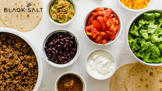 Make Your Own Taco Bar, a versatile setup with an array of fillings and toppings, including seasoned meats (such as beef, chicken, or pork), tortillas, salsa, guacamole, cheese, lettuce, and other condiments, allowing guests to create their own delicious tacos with their preferred combinations.