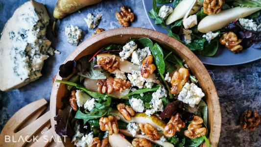 Pear and Candied Walnut Salad, a delightful combination of fresh and crisp mixed greens, juicy pear slices, candied walnuts, and a tangy vinaigrette dressing, offering a refreshing and flavorful salad option.