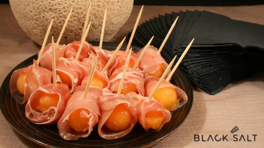 Prosciutto-Wrapped Melon, a delightful combination of sweet and juicy melon wrapped in thin slices of salty prosciutto, offering a delicious and elegant appetizer option with a perfect balance of flavors.