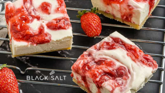 Strawberry Cheesecake Petit Fours, bite-sized treats featuring a creamy and decadent cheesecake layer topped with fresh strawberry slices, all encased in a delicate pastry, offering a delightful and indulgent dessert option.